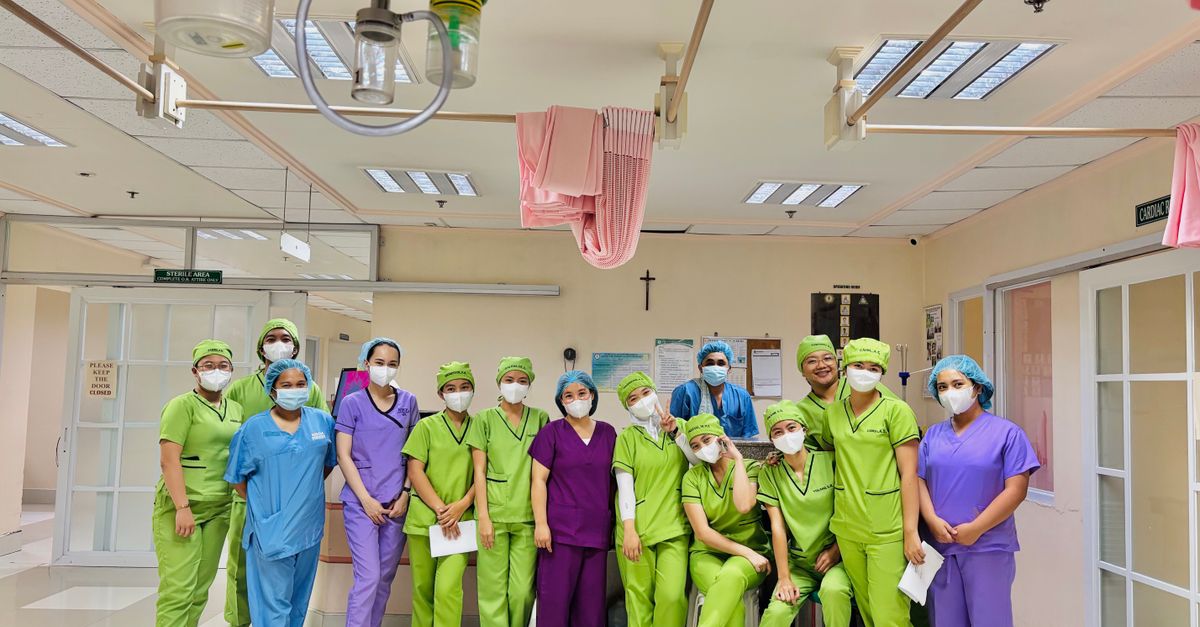 Group of diverse nurses in vivid scrubs inside a hospital ward, Baguio City.