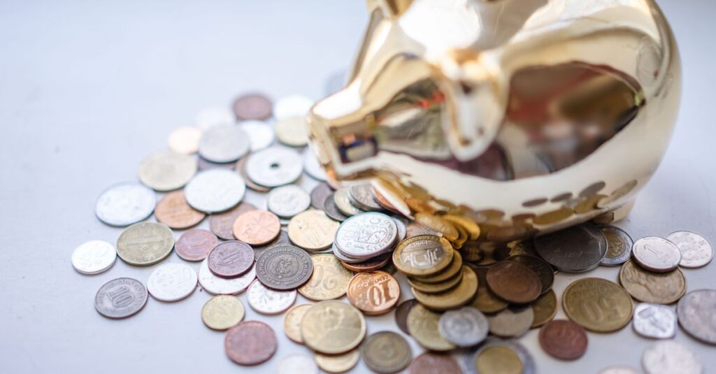 A golden piggy bank surrounded by assorted coins, symbolizing savings and wealth.