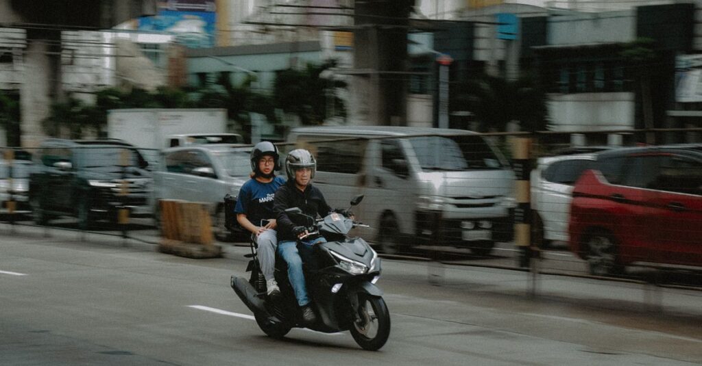 A motorcycle with two riders on a busy street in Quezon City, Metro Manila.