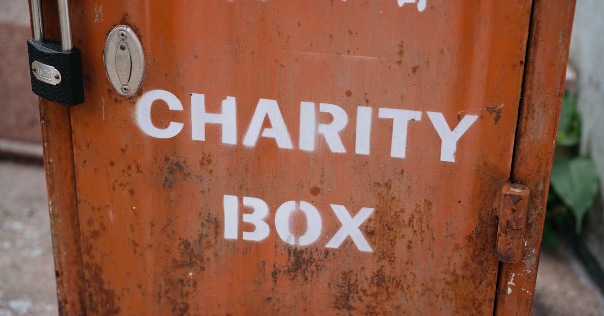 A weathered charity box with a padlock, symbolizing public contribution and community aid.