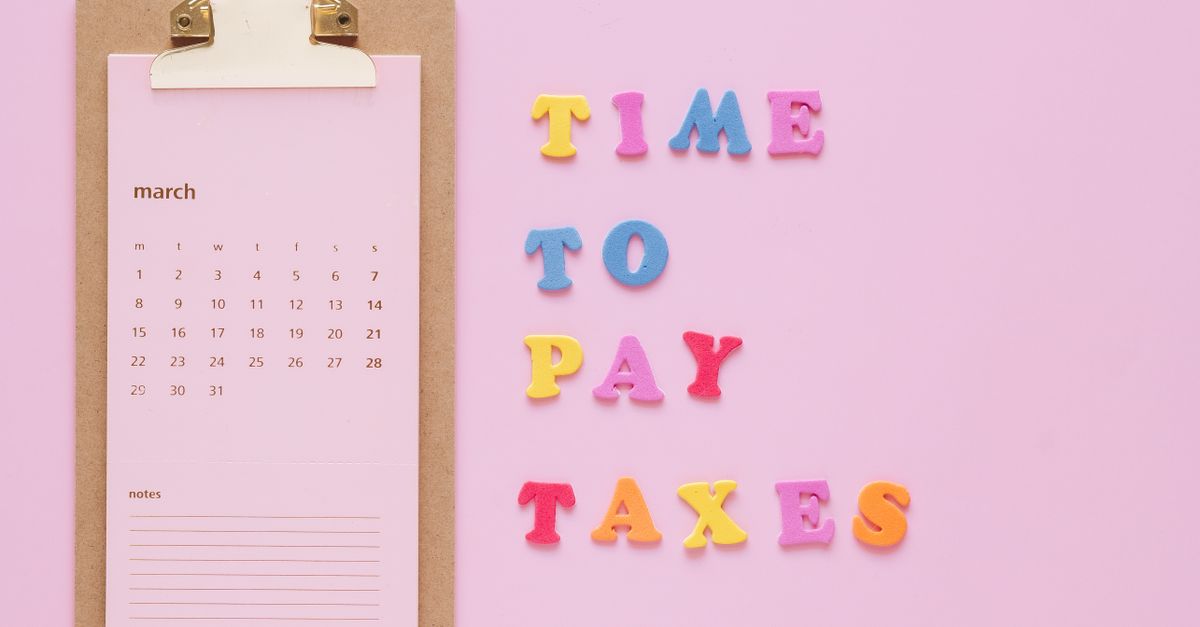 Colorful tax reminder on clipboard against a pink background for March